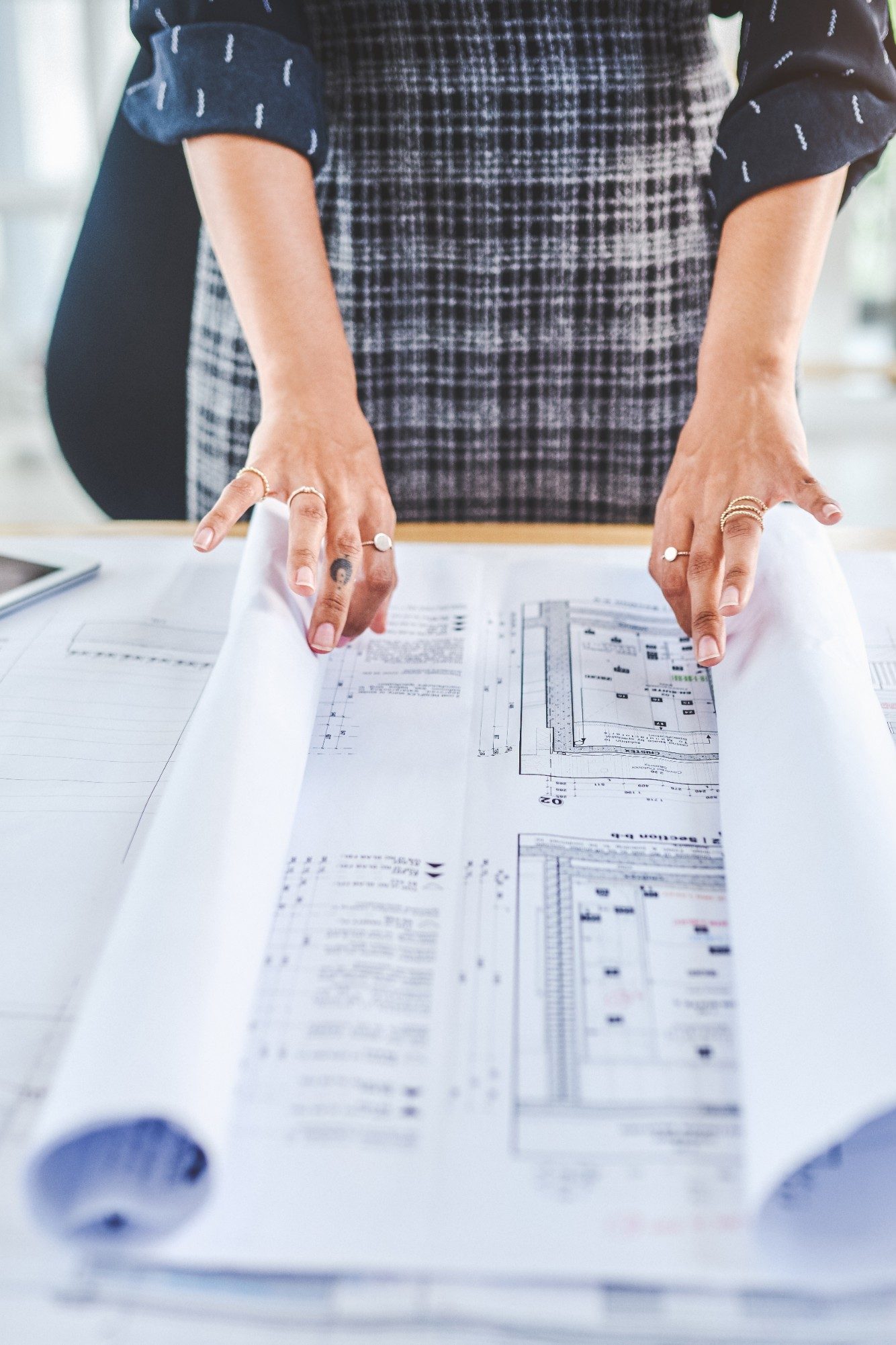 Closeup shot of an unrecognisable businesswoman working with blueprints in an office